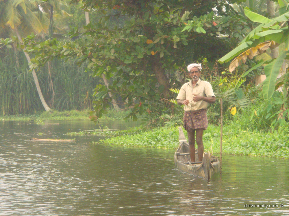 drewmanity.com-man-standing-on-boat-kerala-india-backwaters